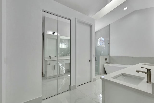 bathroom featuring vanity and shower with separate bathtub