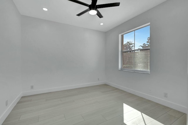 spare room featuring light wood-type flooring and ceiling fan