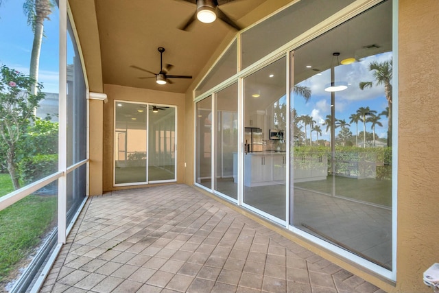 unfurnished sunroom featuring vaulted ceiling