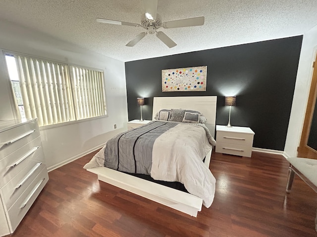 bedroom featuring a textured ceiling, dark hardwood / wood-style floors, and ceiling fan