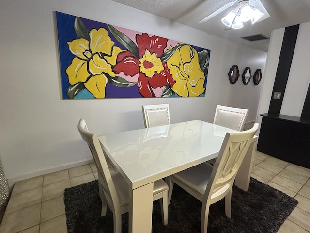 tiled dining area with ceiling fan