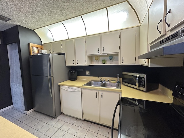 kitchen with sink, light tile patterned floors, extractor fan, and appliances with stainless steel finishes