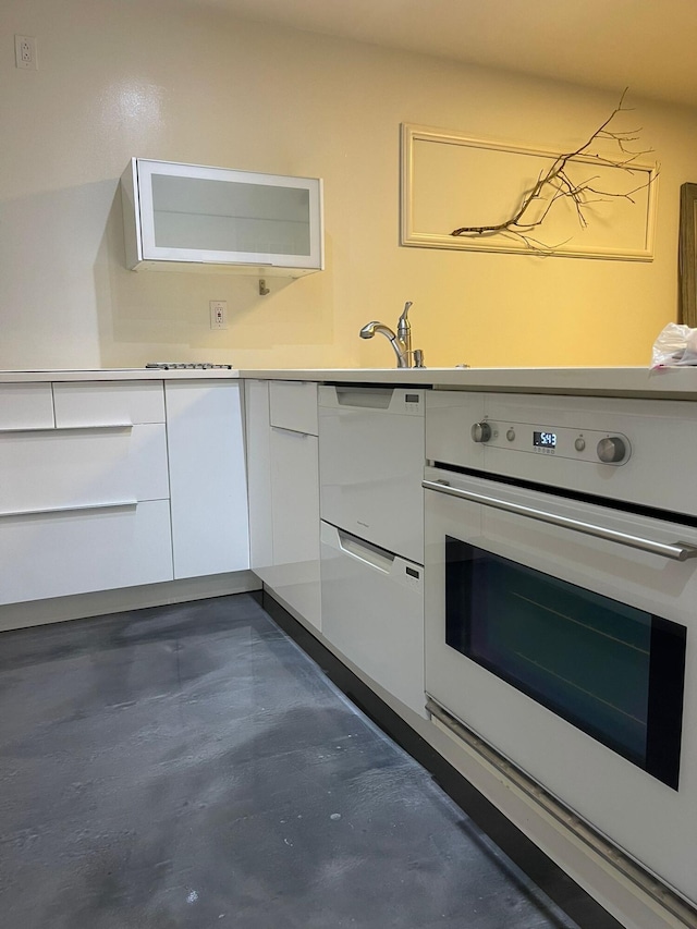 kitchen with white oven and white cabinetry