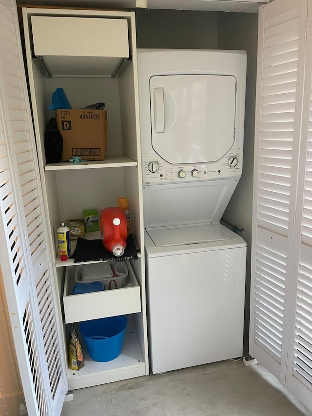 washroom featuring stacked washer and clothes dryer