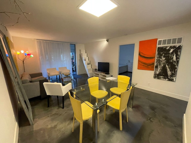 dining room with concrete floors