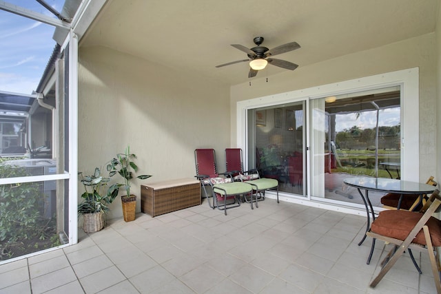 view of patio / terrace featuring ceiling fan and a lanai