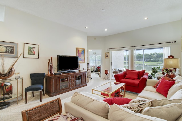 living room with light carpet and a textured ceiling