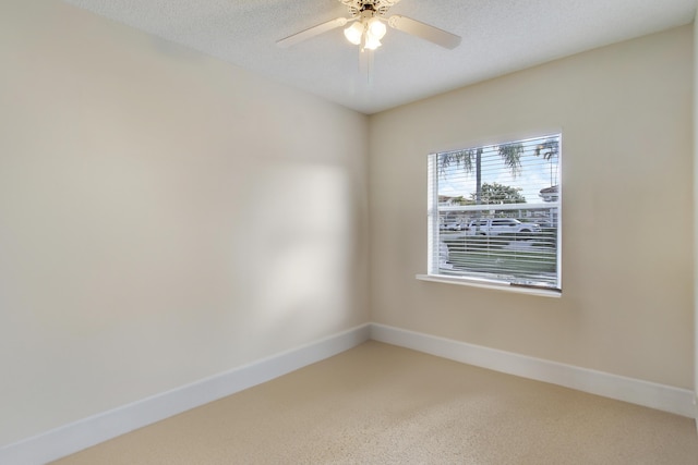 spare room featuring a textured ceiling and ceiling fan