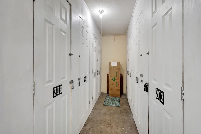 hallway featuring a textured ceiling