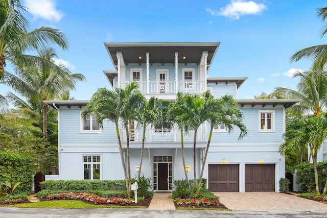 beach home with a garage and a balcony