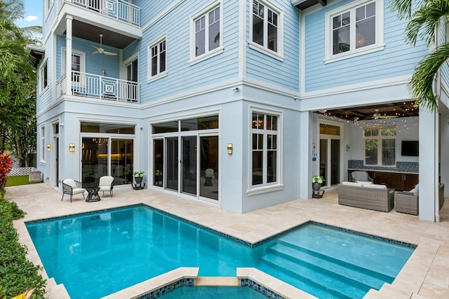 back of house with ceiling fan, an outdoor hangout area, a balcony, and a patio area