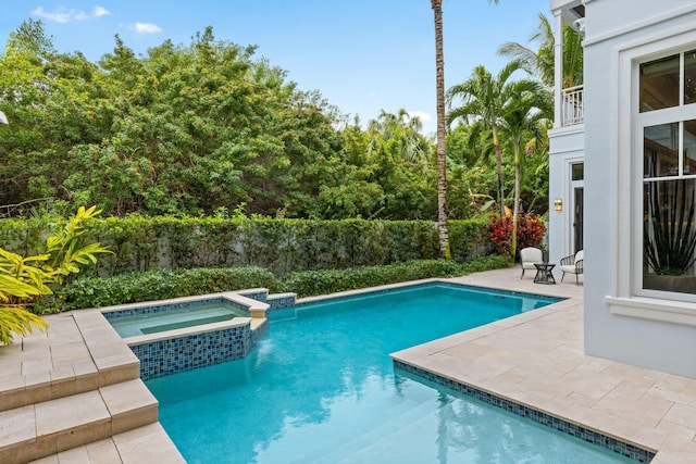 view of swimming pool featuring an in ground hot tub and a patio area