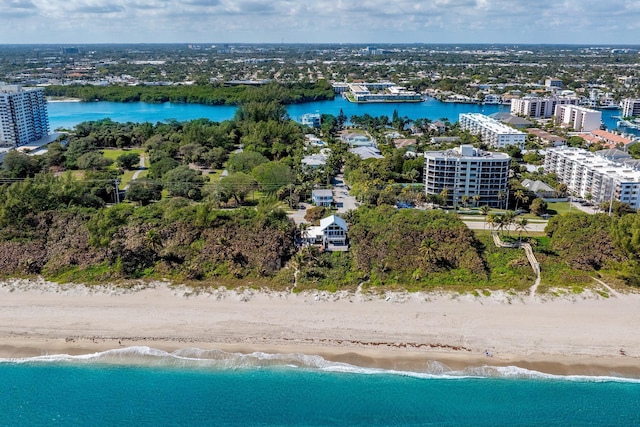 birds eye view of property featuring a water view and a beach view