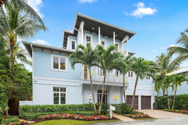 view of front of house with a garage and a balcony