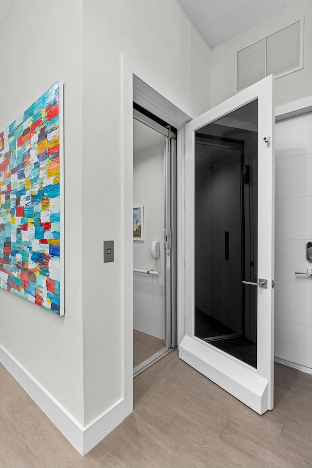 bathroom with hardwood / wood-style floors