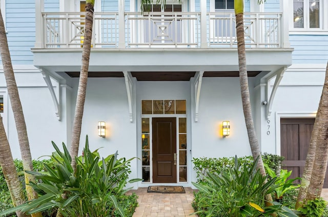 view of exterior entry featuring a balcony