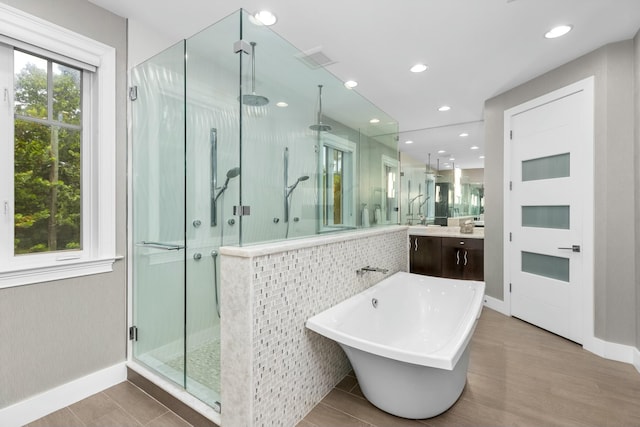 bathroom featuring tile patterned flooring and separate shower and tub