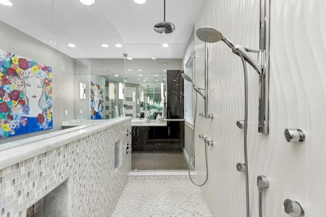 bathroom with vanity, tile patterned floors, and a tile shower