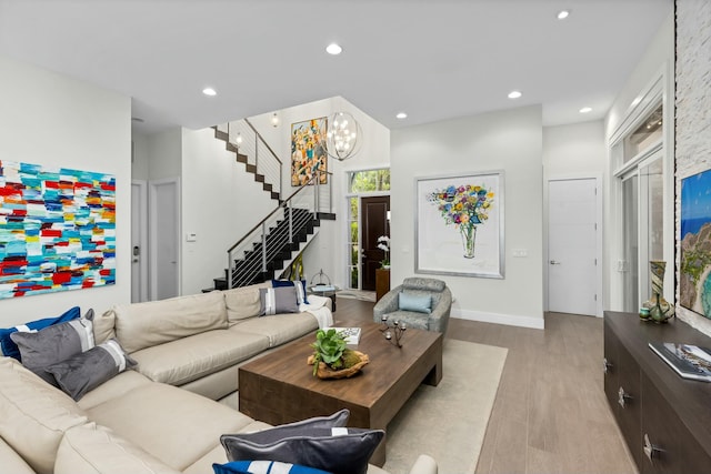 living room with a chandelier and light wood-type flooring