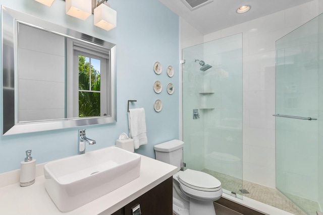 bathroom with vanity, an enclosed shower, and toilet