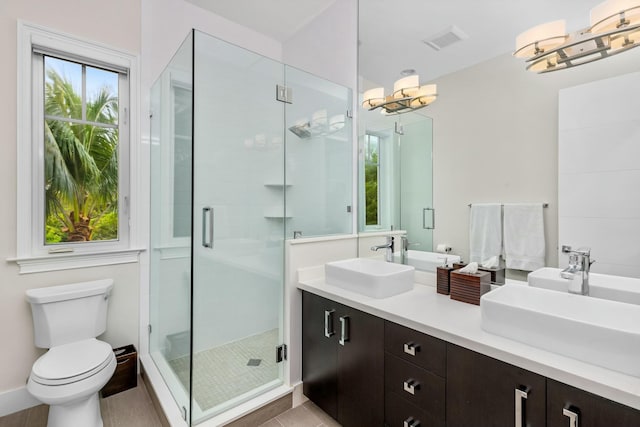 bathroom featuring walk in shower, vanity, and toilet