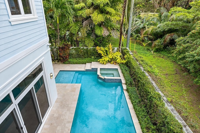 view of swimming pool with an in ground hot tub