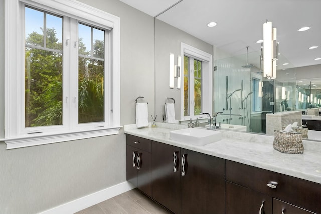 bathroom featuring vanity, hardwood / wood-style floors, and walk in shower