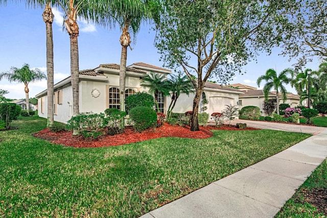 mediterranean / spanish house with a front yard