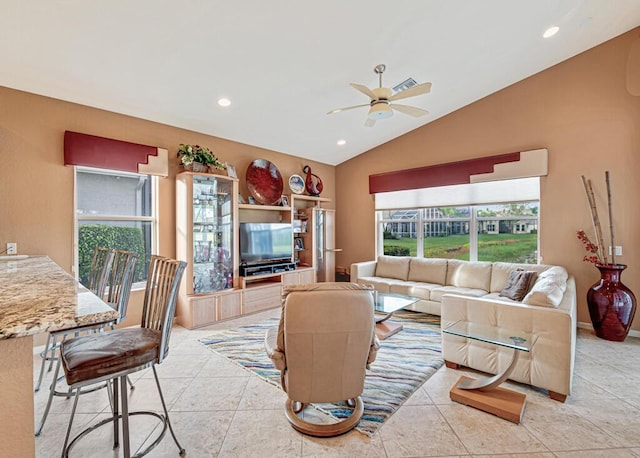 living room with light tile patterned floors, ceiling fan, and lofted ceiling