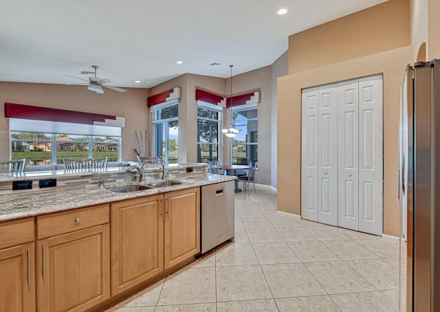 kitchen featuring appliances with stainless steel finishes, ceiling fan, sink, light tile patterned floors, and pendant lighting