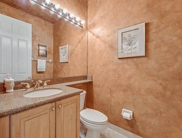 bathroom with tile patterned floors, vanity, and toilet