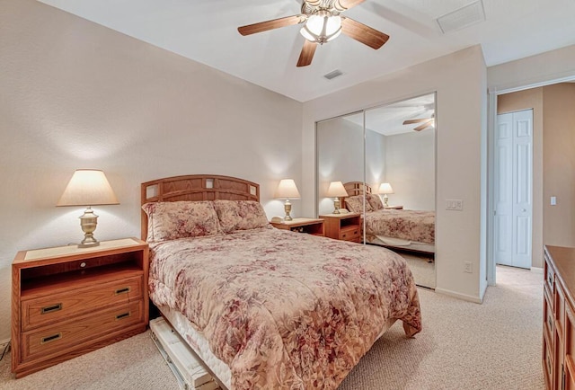 bedroom with light carpet, a closet, and ceiling fan