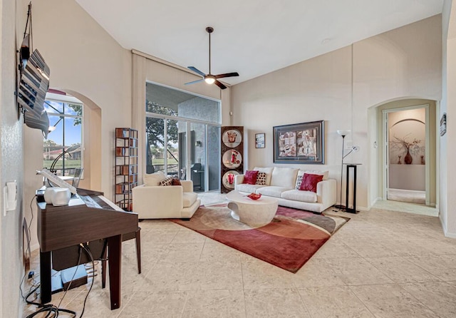 living room with high vaulted ceiling and ceiling fan