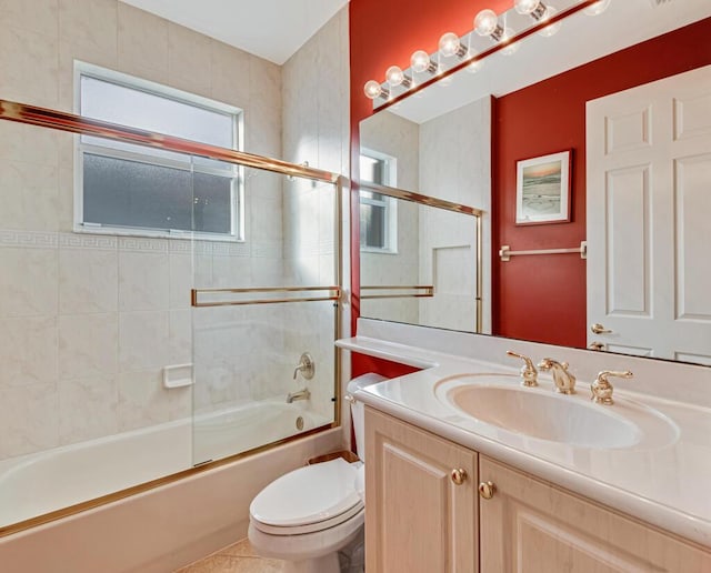 full bathroom featuring combined bath / shower with glass door, vanity, and toilet