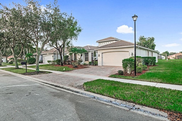 view of front of home with a garage and a front lawn