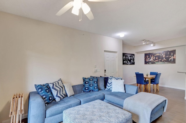 living room with radiator heating unit, a textured ceiling, hardwood / wood-style flooring, and ceiling fan