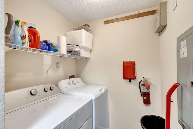 laundry area featuring washer and dryer and a textured ceiling