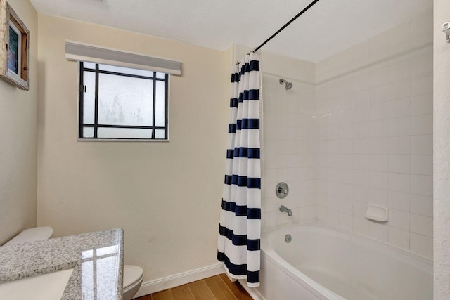 full bathroom featuring vanity, shower / bath combo, and toilet