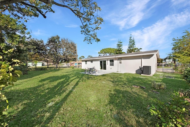 view of yard with central AC and a patio area