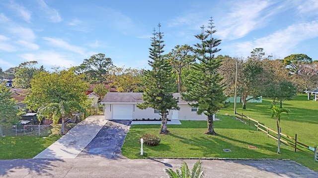 view of front of property featuring a front yard and a garage