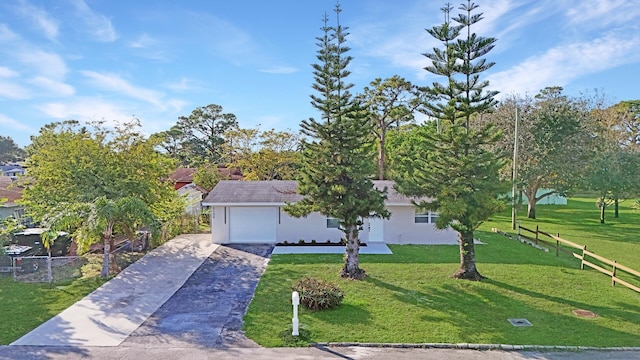 view of front of property featuring a front lawn and a garage