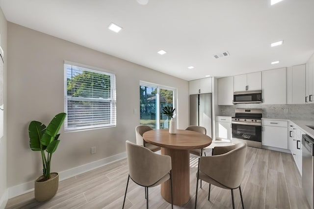 dining space featuring light hardwood / wood-style floors