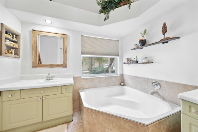 bathroom featuring vanity, tile patterned flooring, and tiled bath