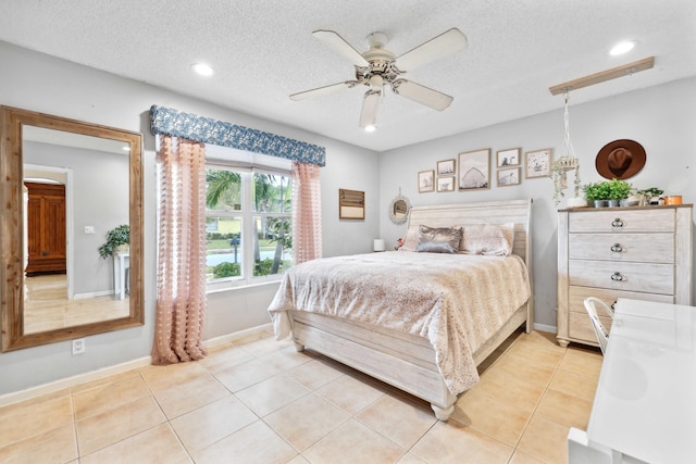 tiled bedroom with a textured ceiling and ceiling fan