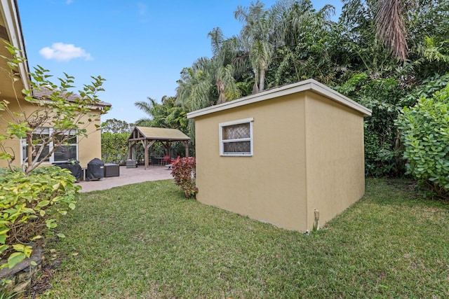 view of outbuilding featuring a gazebo and a lawn