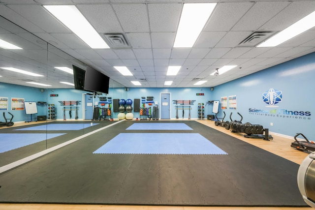 workout area with a paneled ceiling