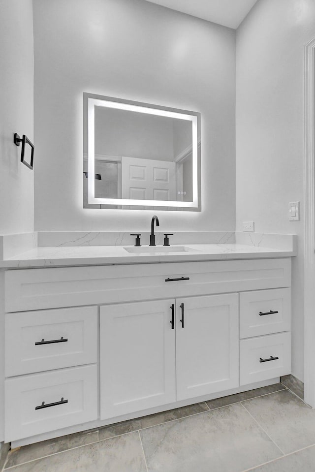 bathroom with tile patterned floors and vanity