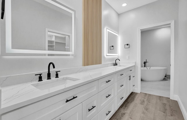 bathroom featuring a bathtub, vanity, and hardwood / wood-style flooring