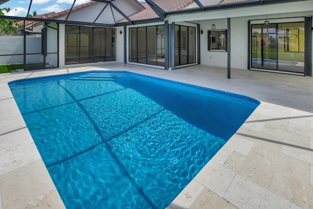 view of pool with a patio and a lanai