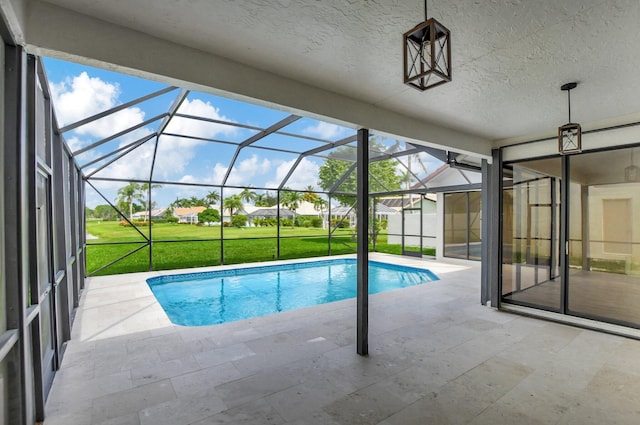 view of swimming pool with a yard, a lanai, and a patio area